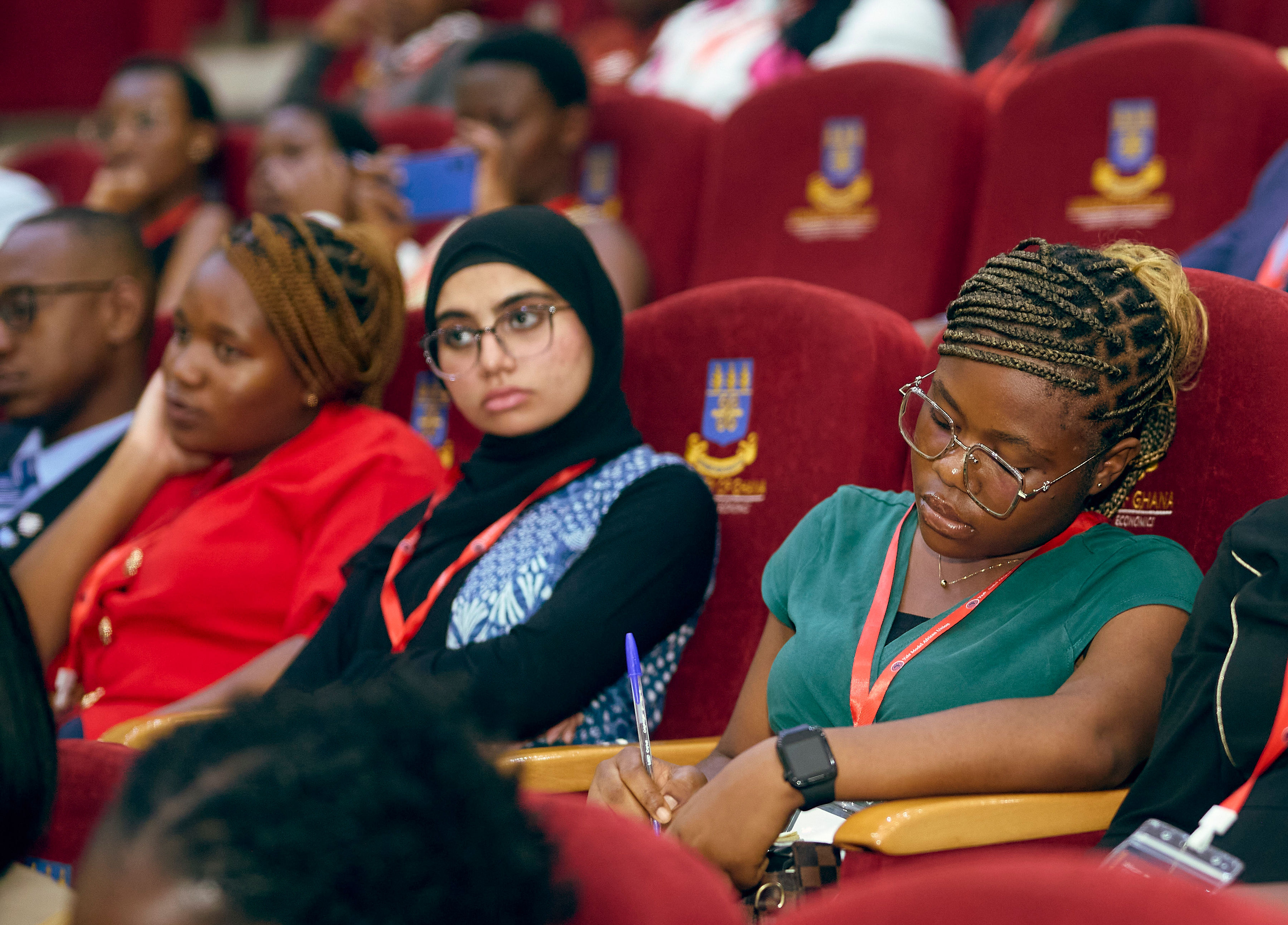 A YMAU V delegate taking notes during a plenary session
