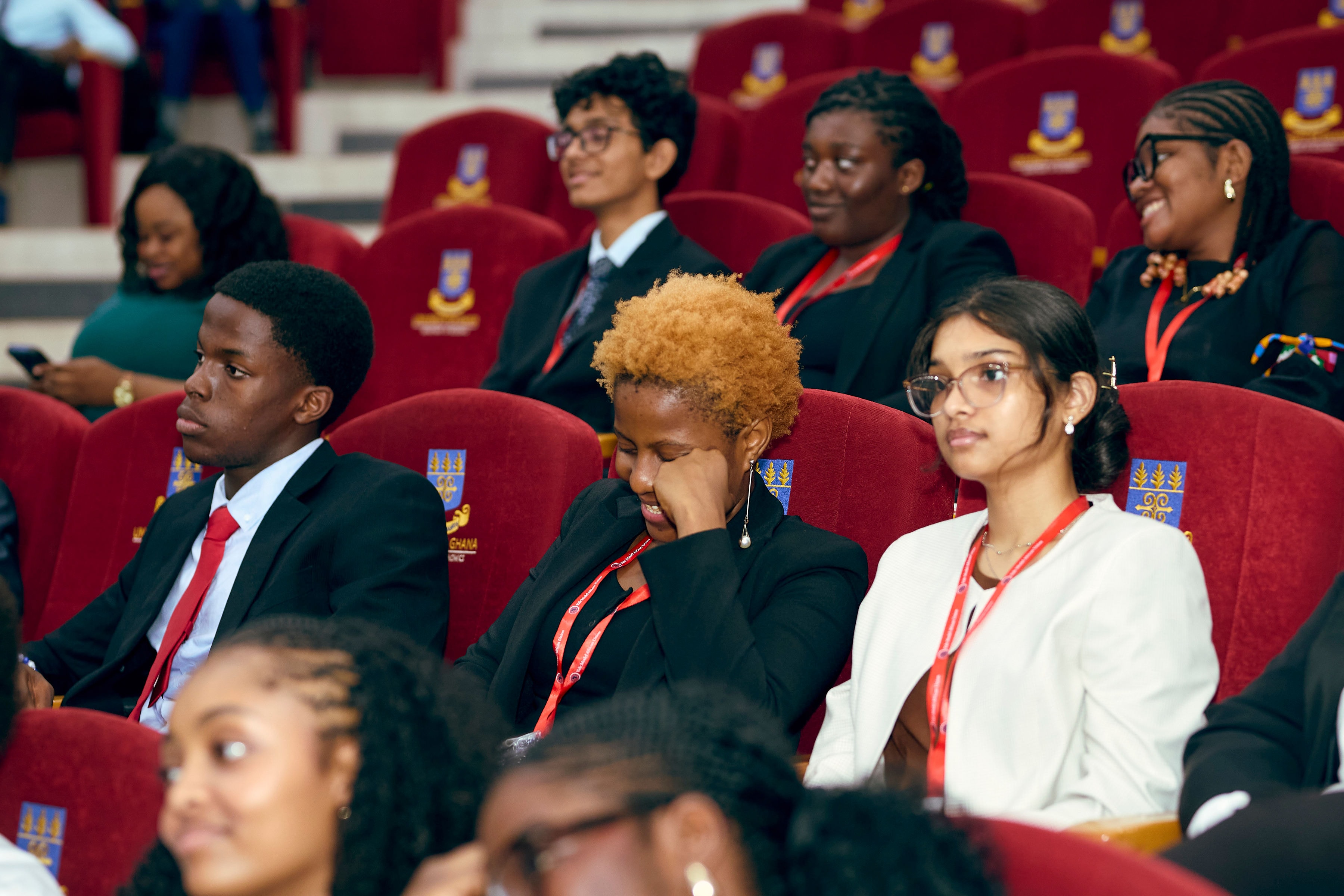 Young YMAU V delegates seated together in the auditorium