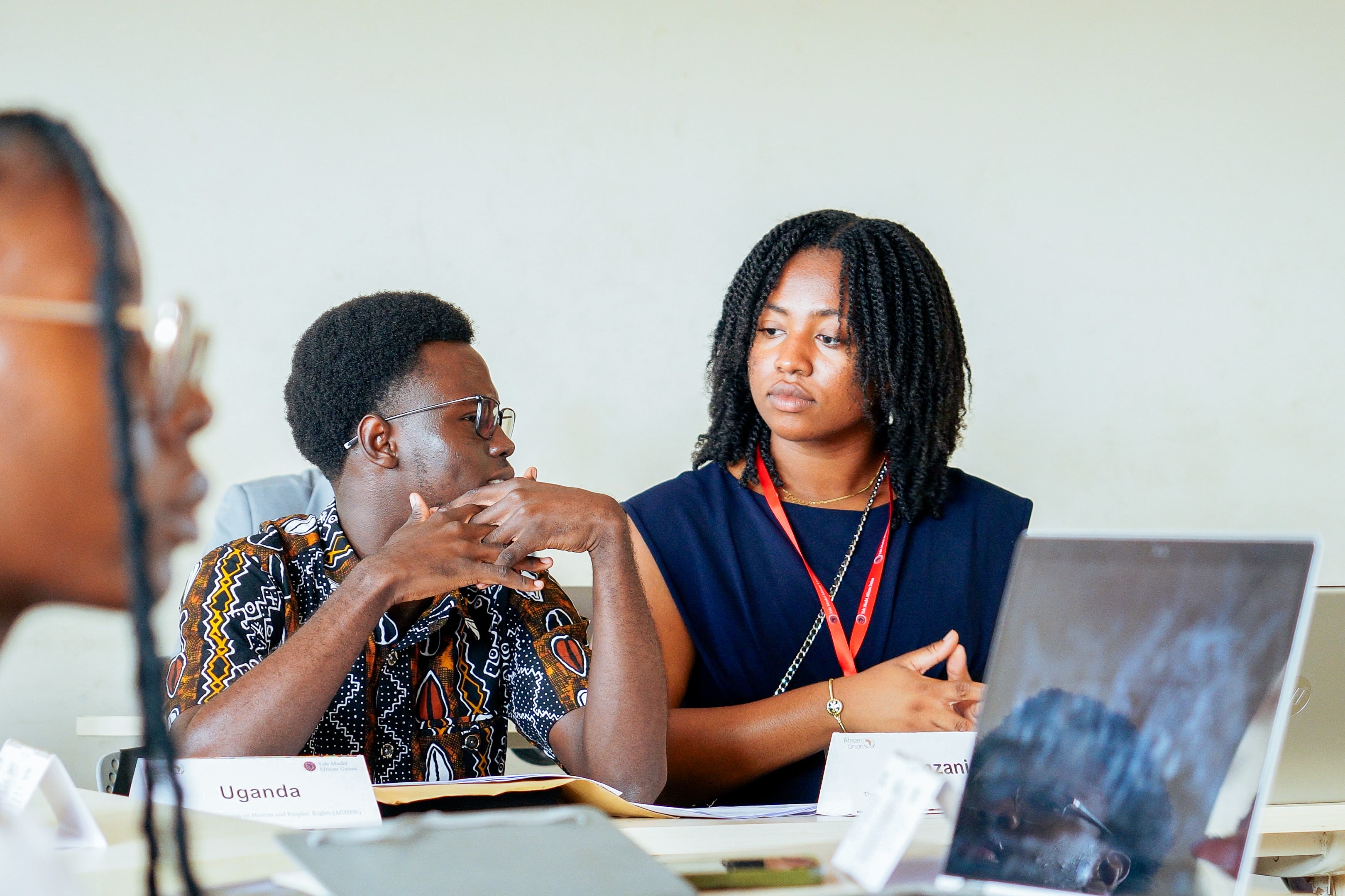 YMAU V delegates in focused discussion during a committee session