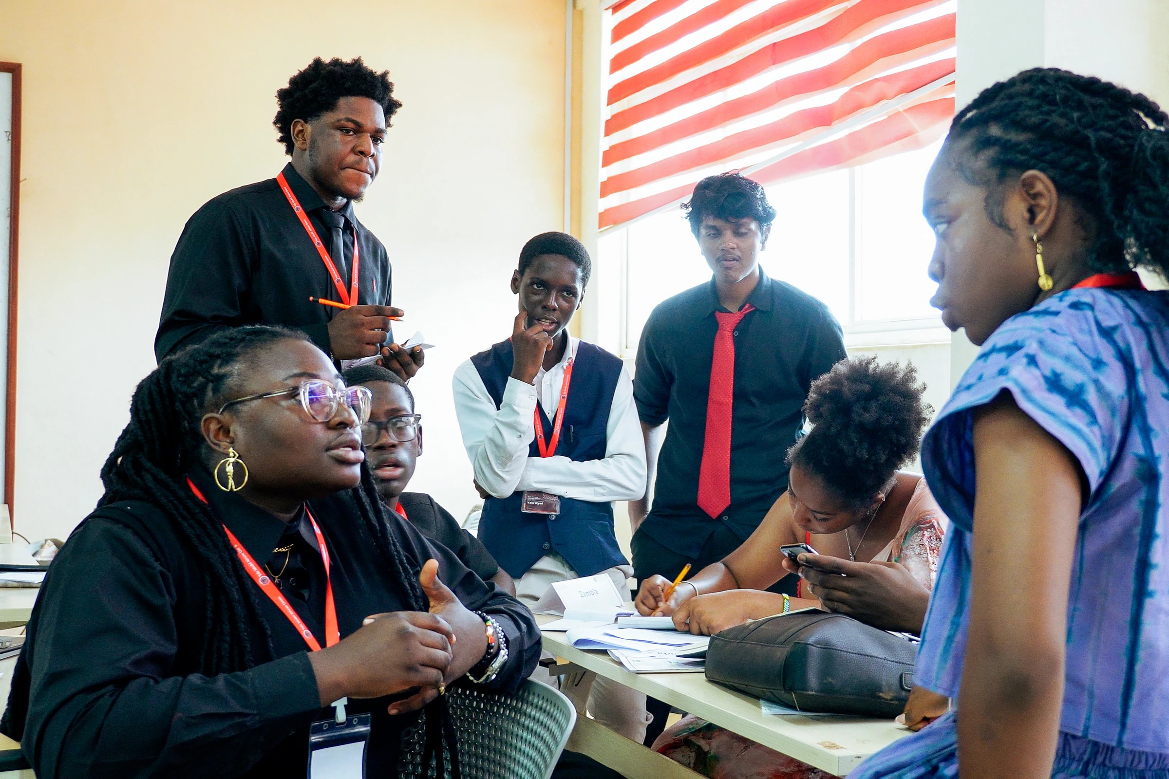 Delegates exchanging ideas across a YMAU V committee table