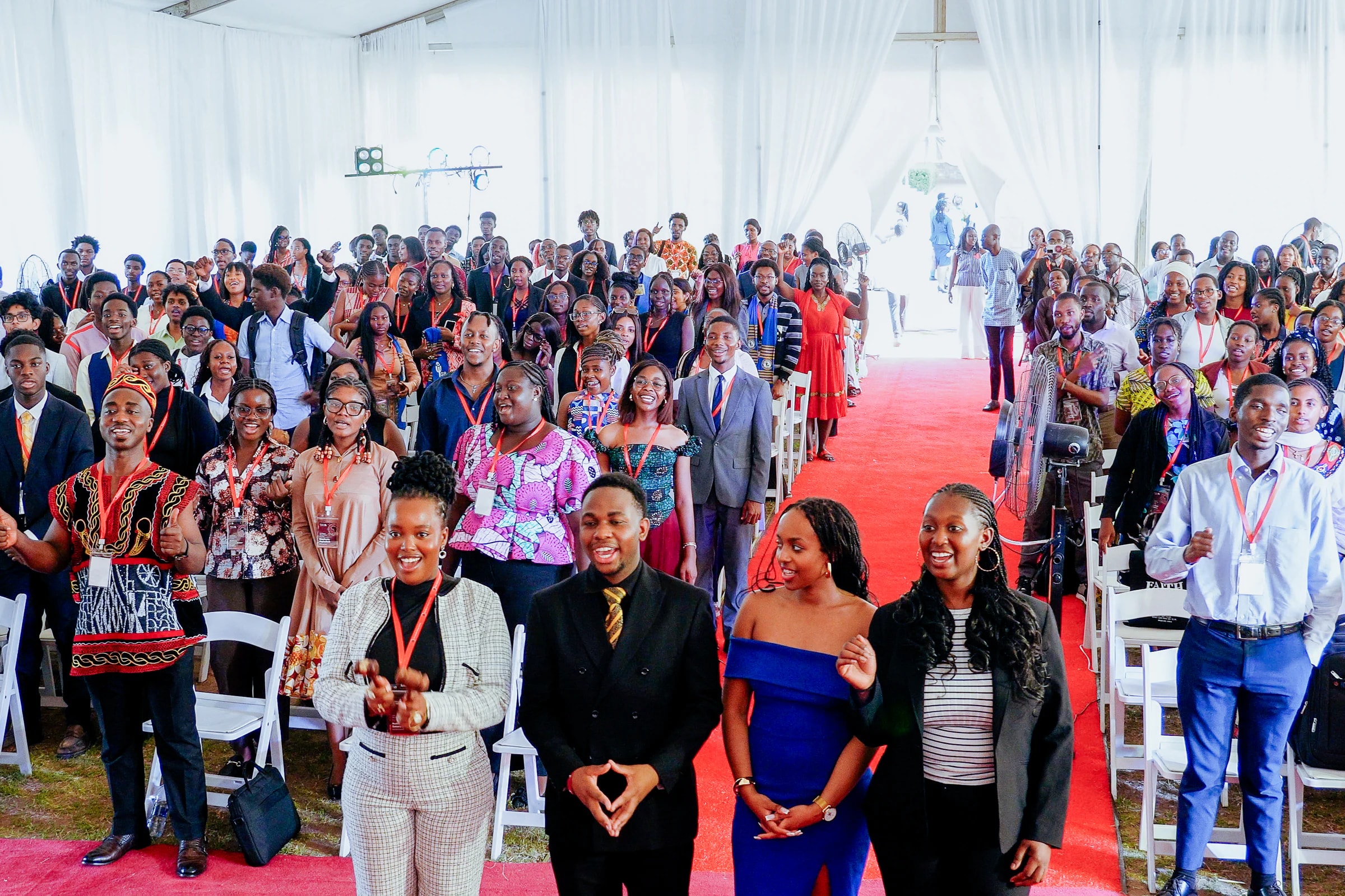 Delegates gathered in the aisle at the close of YMAU V