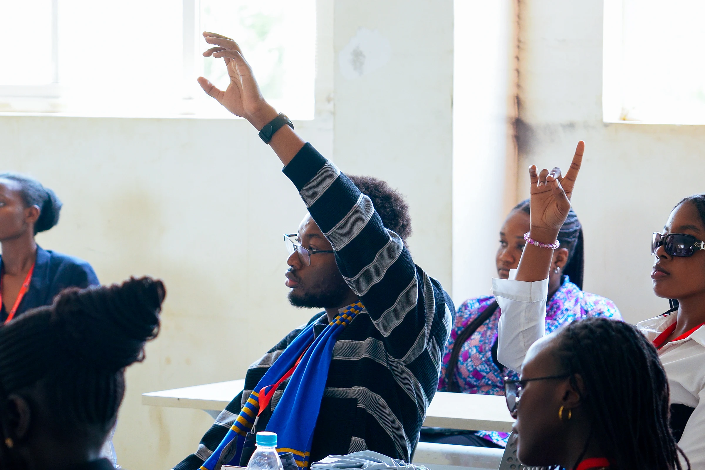 Delegates raising their hands during YMAU V leadership training